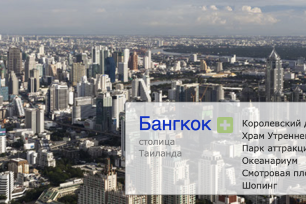 Colorful assortment of fresh vegetables on a wooden table, including tomatoes, peppers, and carrots.