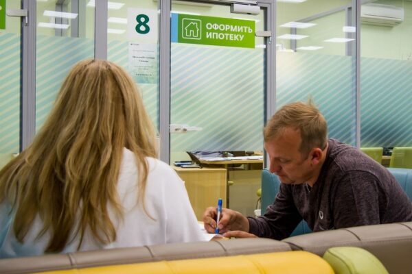 Moderner Büroarbeitsplatz mit Computer, Schreibtisch, Stuhl und Pflanzen.