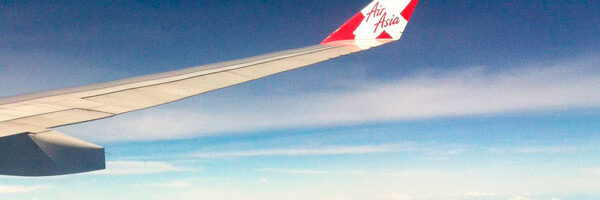 Modern office desk with laptop, stationery, and plant